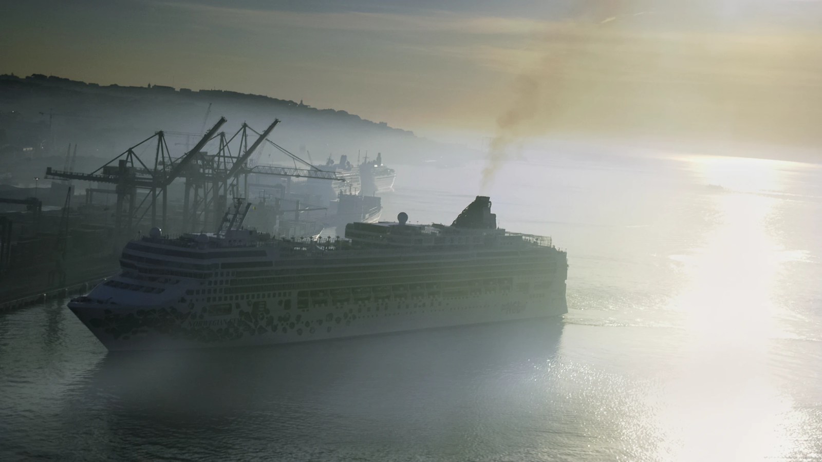 cruise ship sailing through polluted harbor